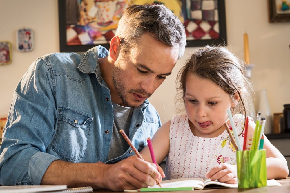 Father and daughter doing homework
